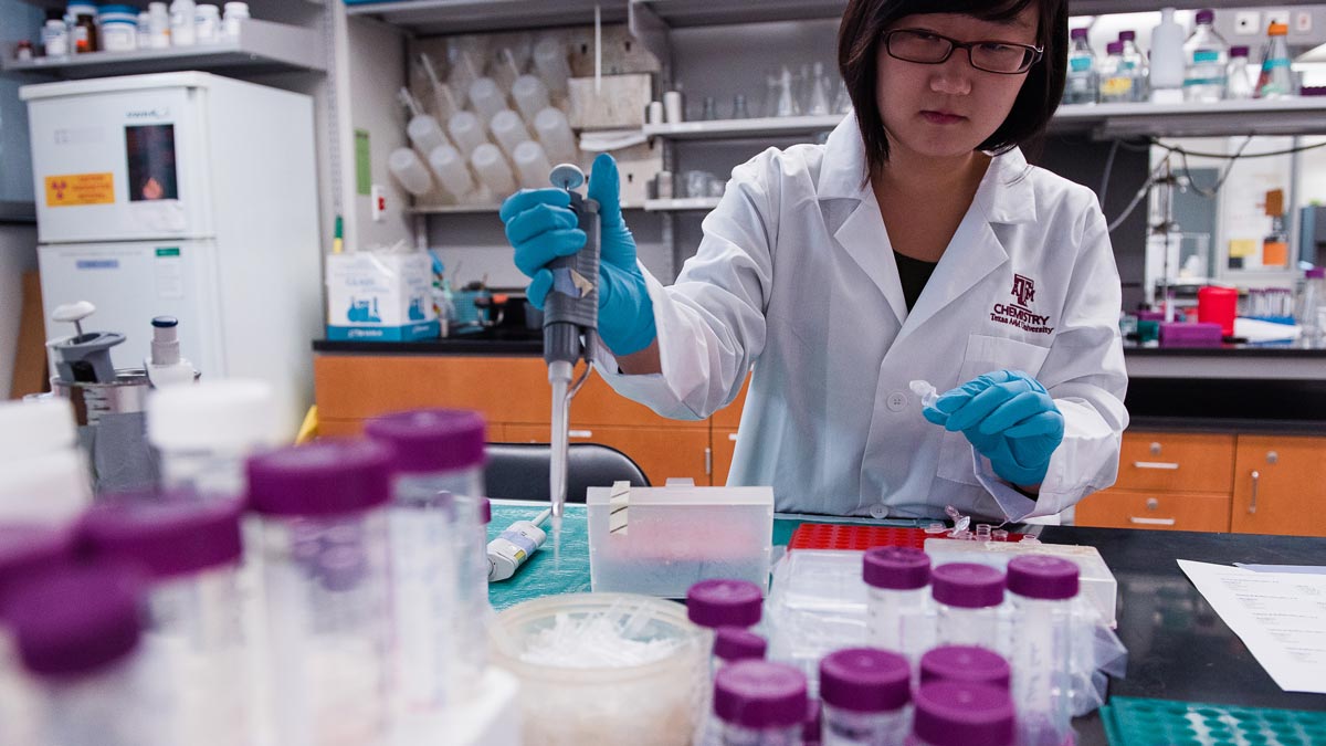 A chemistry grad student handling a pipette